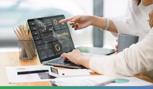 Analyzing CRM Data on Microsoft Dynamics 365 Dashboard Professionals analyzing customer insights and performance metrics using Microsoft Dynamics 365 CRM dashboard on a laptop