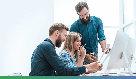 Aegis Dynamics 365 CRM Consultants Collaborating on Implementation Strategy Team of Microsoft-certified Dynamics 365 CRM consultants discussing CRM implementation strategy at Aegis