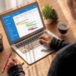 A software engineer working on some app data on his laptop