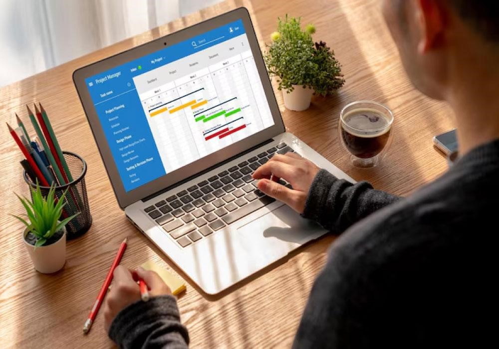 A software engineer working on some app data on his laptop